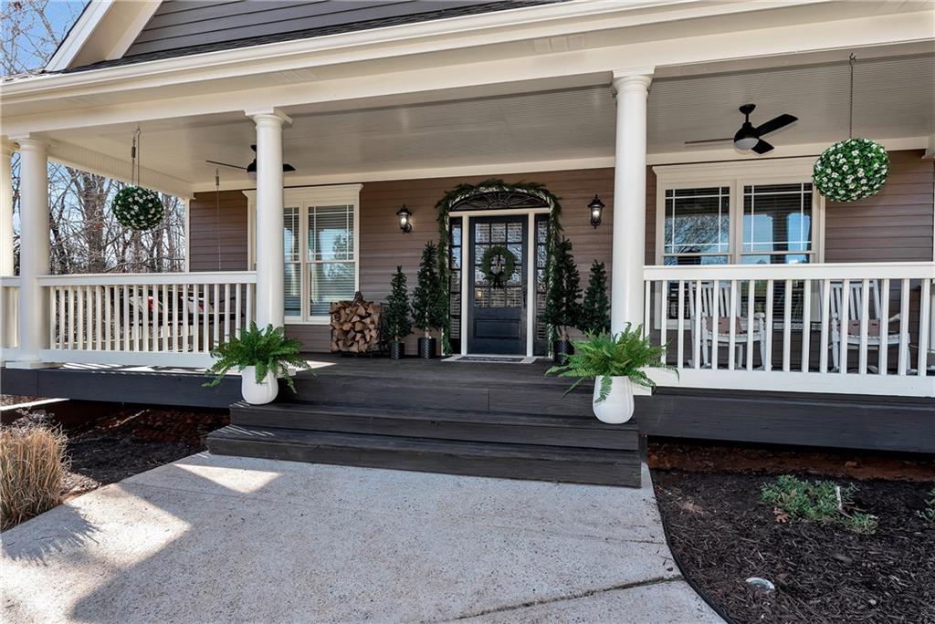 321 Chumbley Road Dawsonville, GA 30534 - Photo 3 of 65 a view of a house with a bench and wooden floor