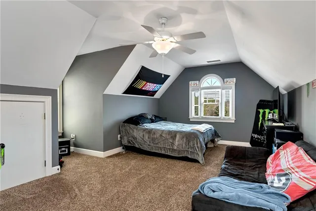 a living room with furniture a window and a clock
