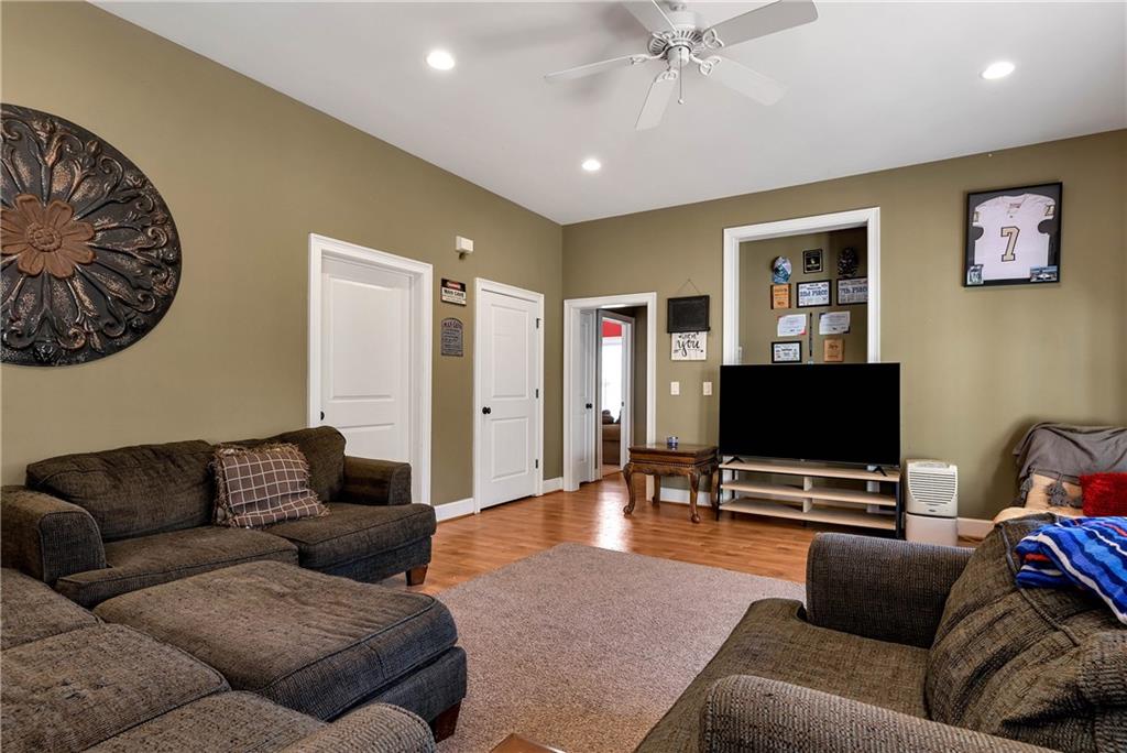 321 Chumbley Road Dawsonville, GA 30534 - Photo 37 of 65 a living room with furniture and a flat screen tv