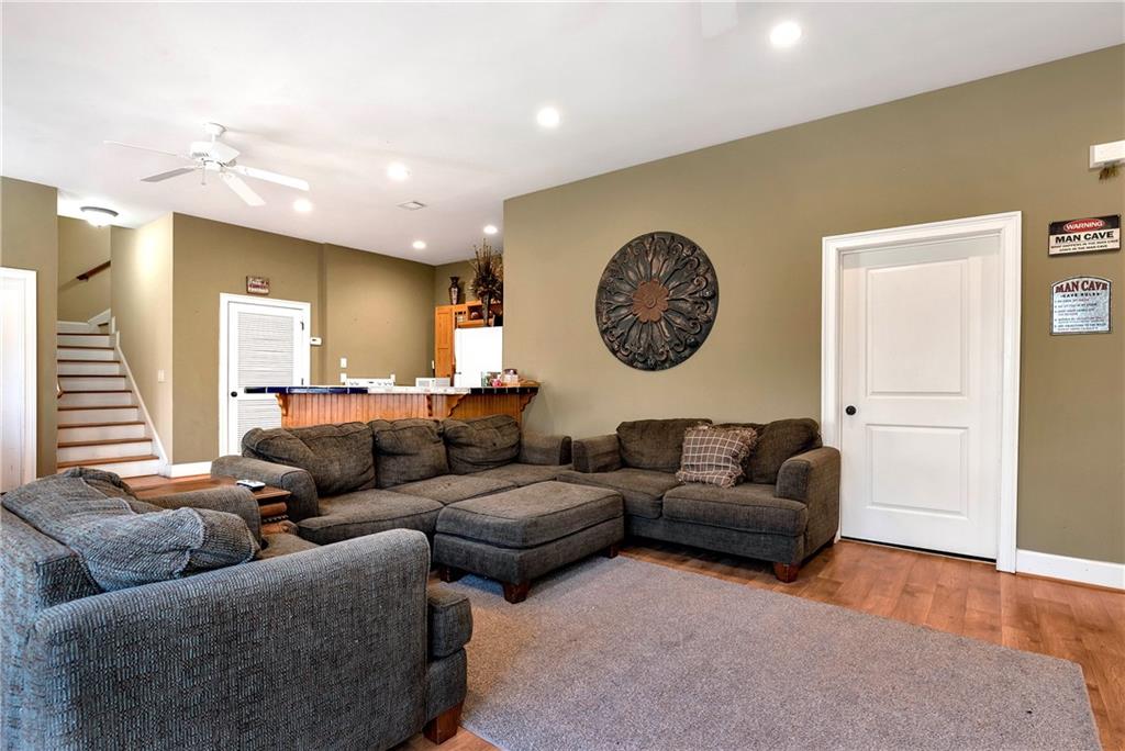 321 Chumbley Road Dawsonville, GA 30534 - Photo 38 of 65 a living room with furniture a window and a clock