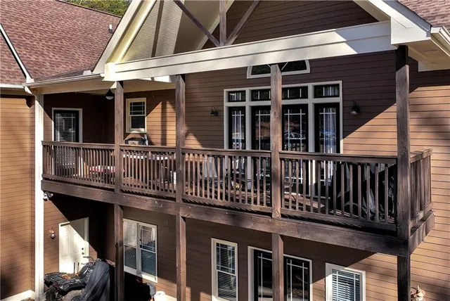 a front view of a house with yard and trees