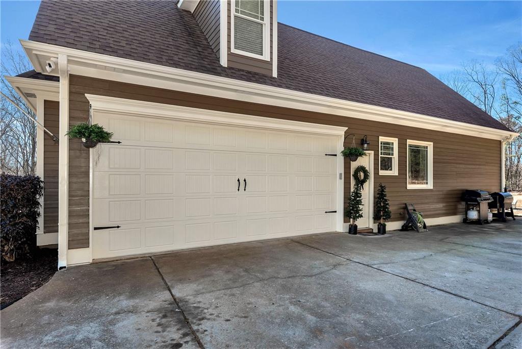 321 Chumbley Road Dawsonville, GA 30534 - Photo 53 of 65 a view of a garage with parked cars