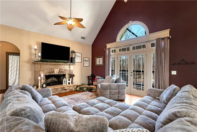 a living room with furniture a flat screen tv and a fireplace