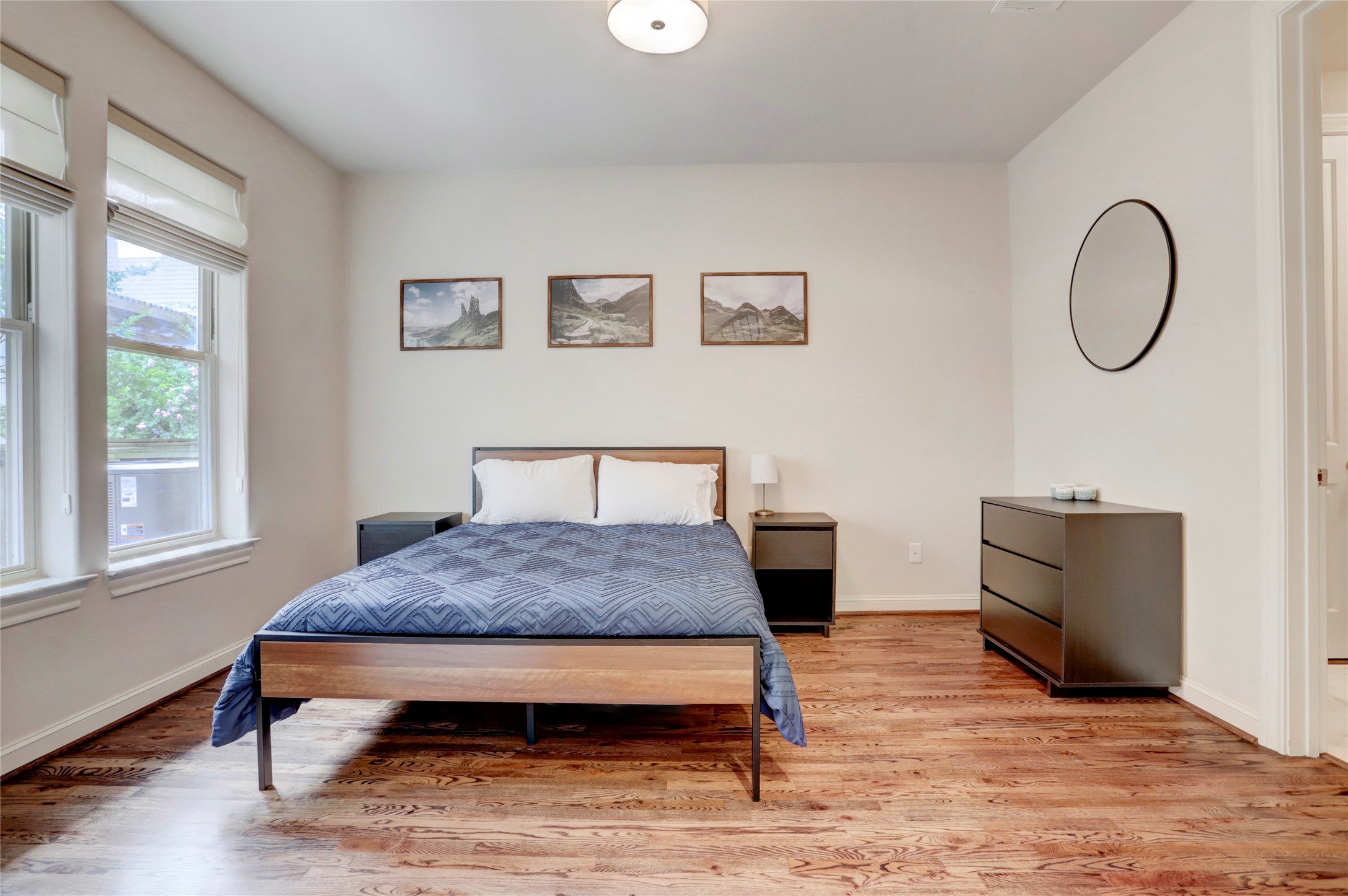 1348 West 25th Street Houston, TX 77008 - Photo 11 of 34 a bedroom with a bed and wooden floor