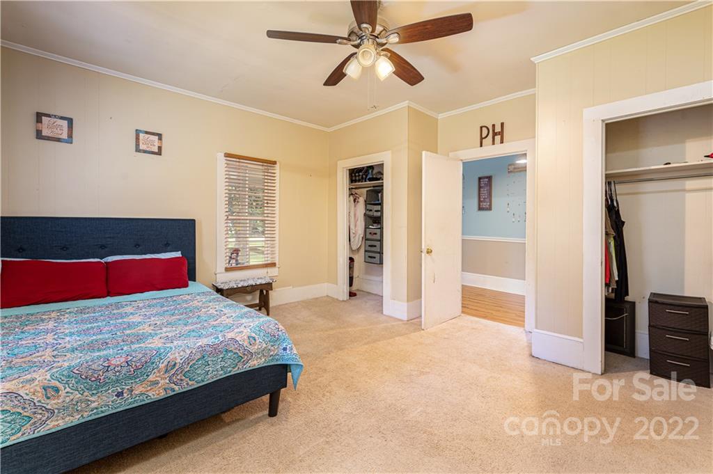 1212 Tot Dellinger Road Cherryville, NC 28021 - Photo 11 of 46 a bedroom with a large bed and a chandelier