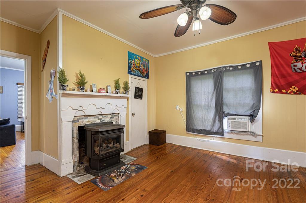 1212 Tot Dellinger Road Cherryville, NC 28021 - Photo 13 of 46 a living room with a fireplace and a flat screen tv