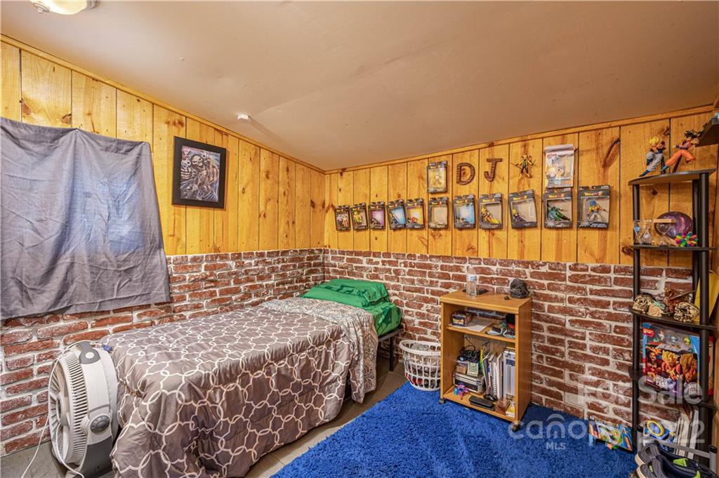 1212 Tot Dellinger Road Cherryville, NC 28021 - Photo 18 of 46 a bedroom with a bed and a wall painting