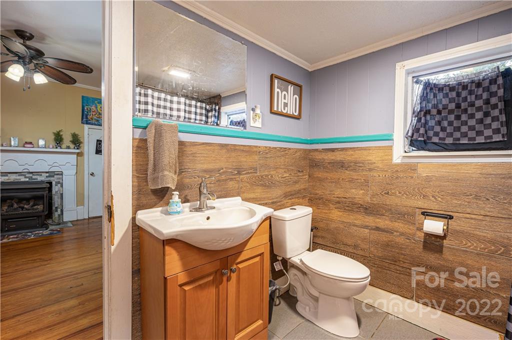 1212 Tot Dellinger Road Cherryville, NC 28021 - Photo 19 of 46 a bathroom with a sink toilet and mirror