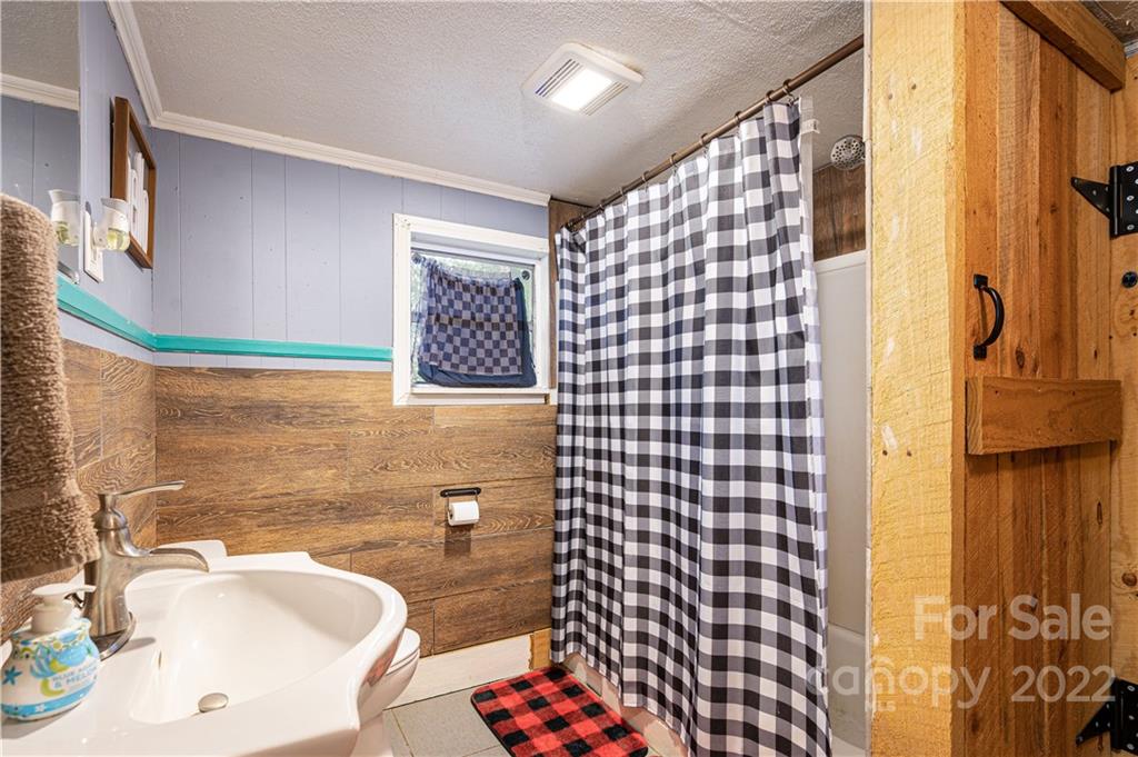1212 Tot Dellinger Road Cherryville, NC 28021 - Photo 20 of 46 a bathroom with a sink toilet and shower