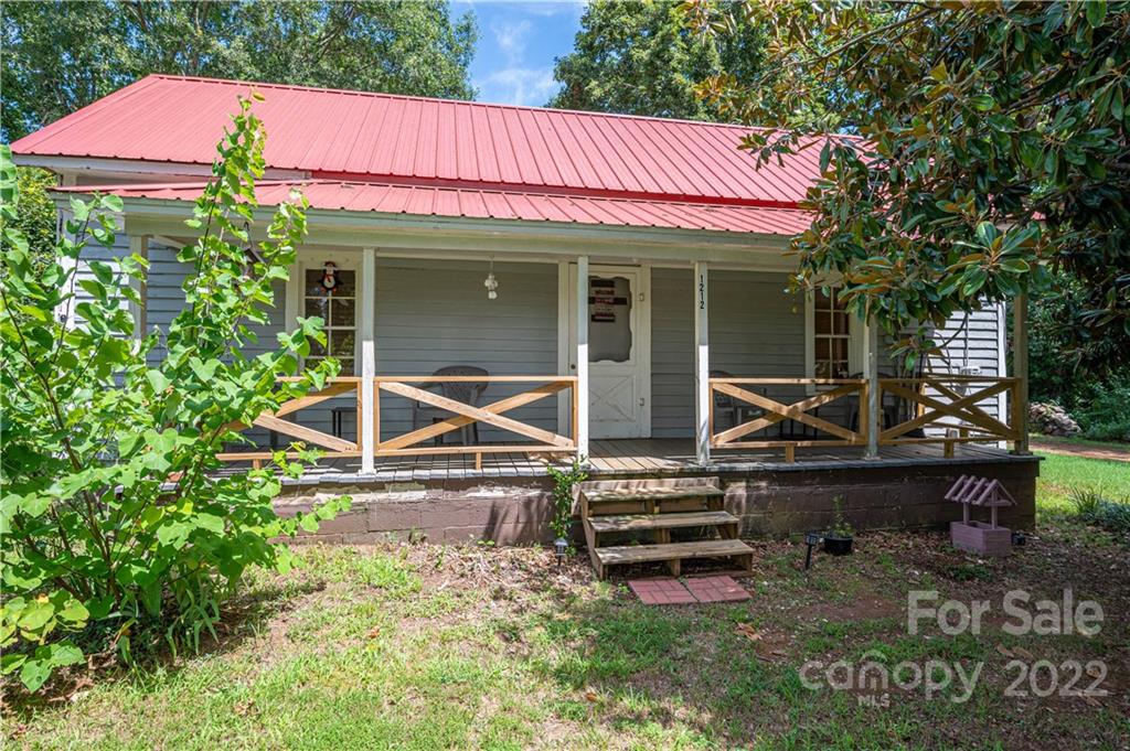 1212 Tot Dellinger Road Cherryville, NC 28021 - Photo 21 of 46 a backyard of a house with barbeque oven table and chairs