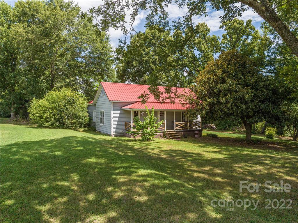 1212 Tot Dellinger Road Cherryville, NC 28021 - Photo 22 of 46 a backyard of a house with yard and outdoor seating