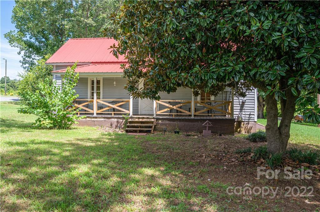 1212 Tot Dellinger Road Cherryville, NC 28021 - Photo 29 of 46 a view of backyard with table and chairs and a large tree