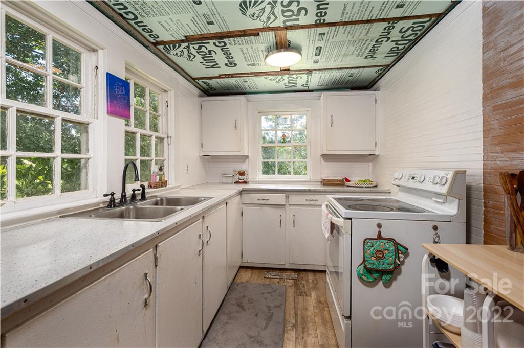 1212 Tot Dellinger Road Cherryville, NC 28021 - Photo 10 of 46 a kitchen with a sink window and cabinets