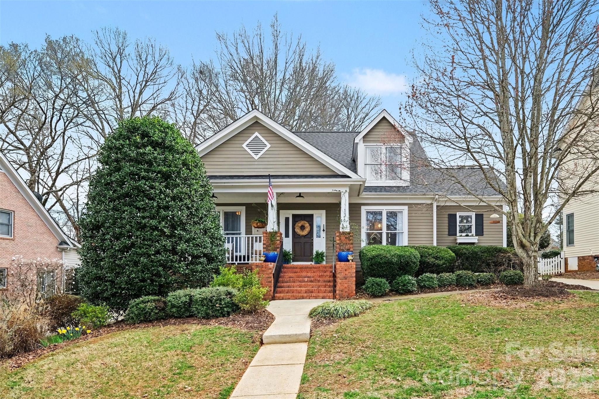 a front view of a house with garden