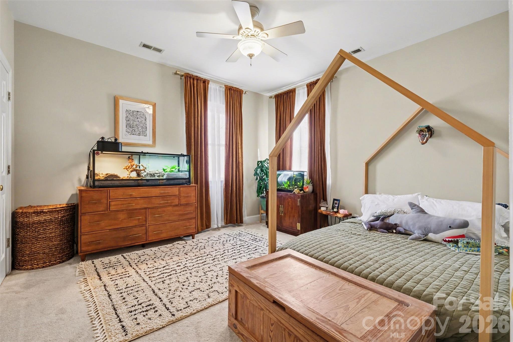 136 Spencer Street Davidson, NC 28036 - Photo 11 of 42 a bedroom with a bed and a dresser
