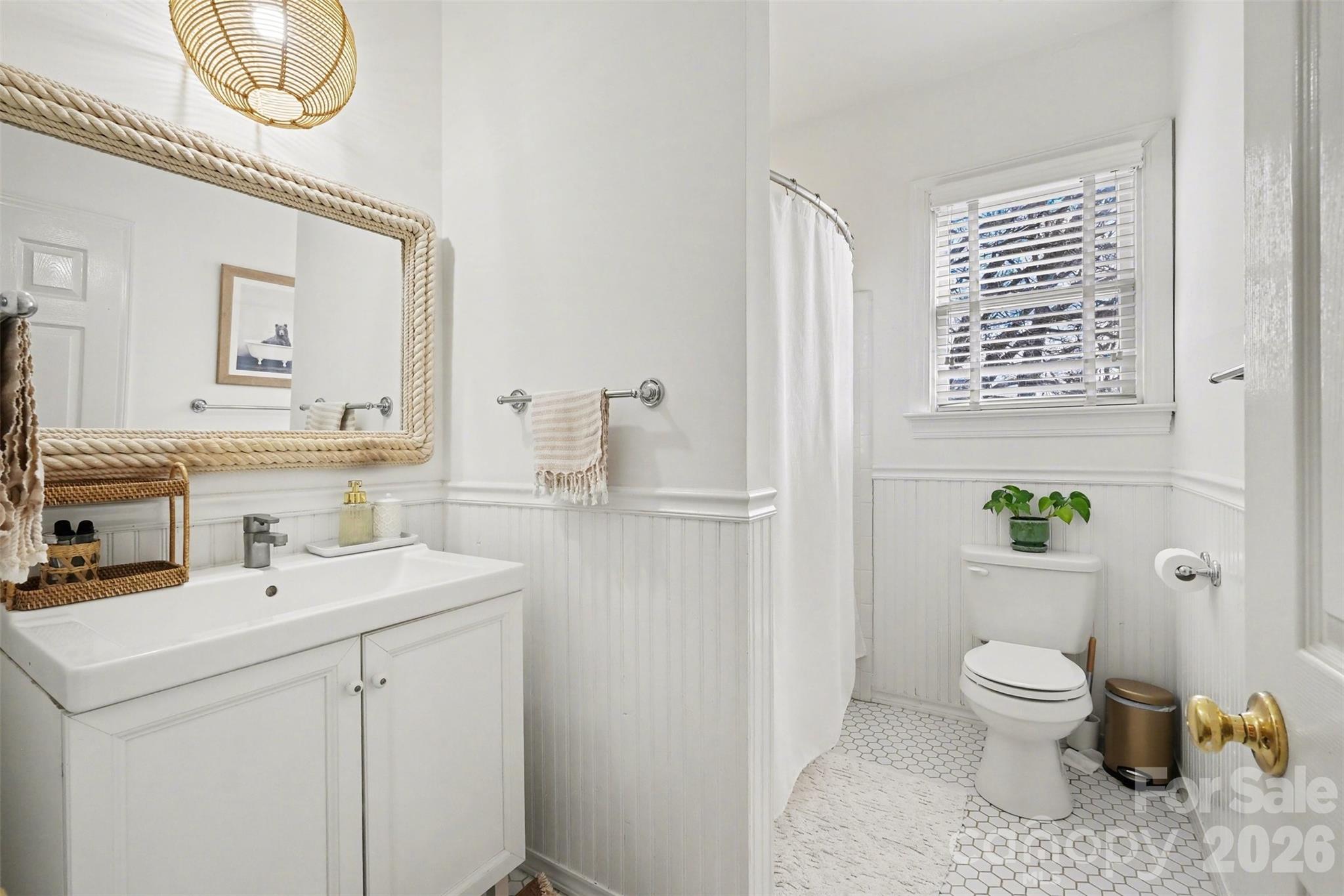 136 Spencer Street Davidson, NC 28036 - Photo 12 of 42 a bathroom with a toilet a sink and a mirror