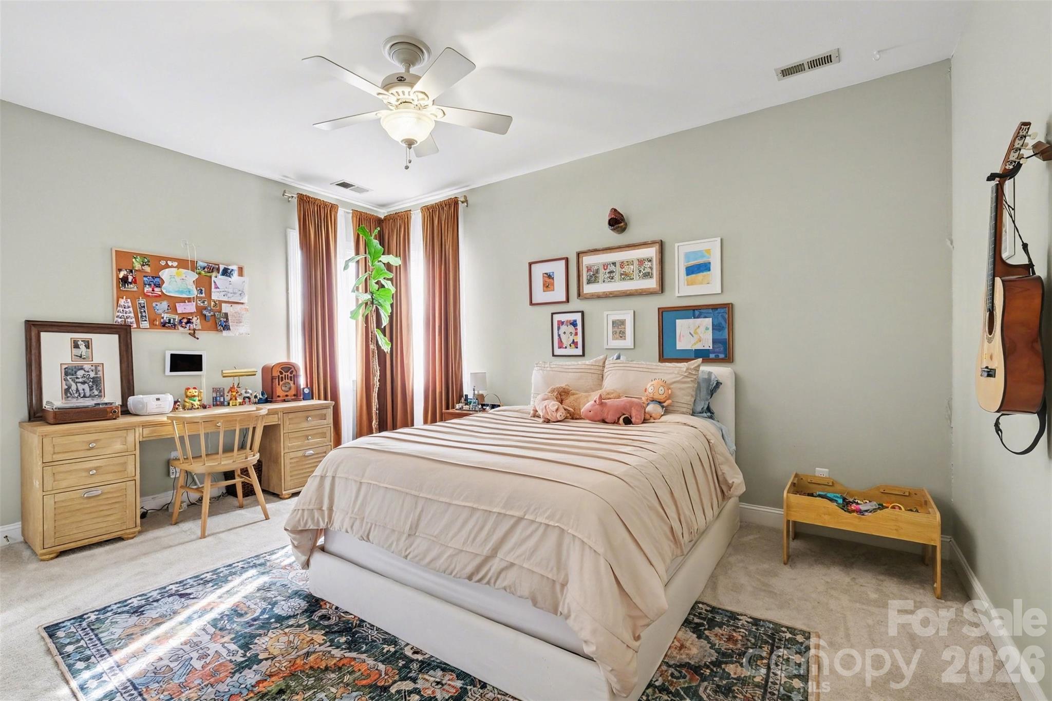 136 Spencer Street Davidson, NC 28036 - Photo 13 of 42 a bedroom with a bed and a chandelier