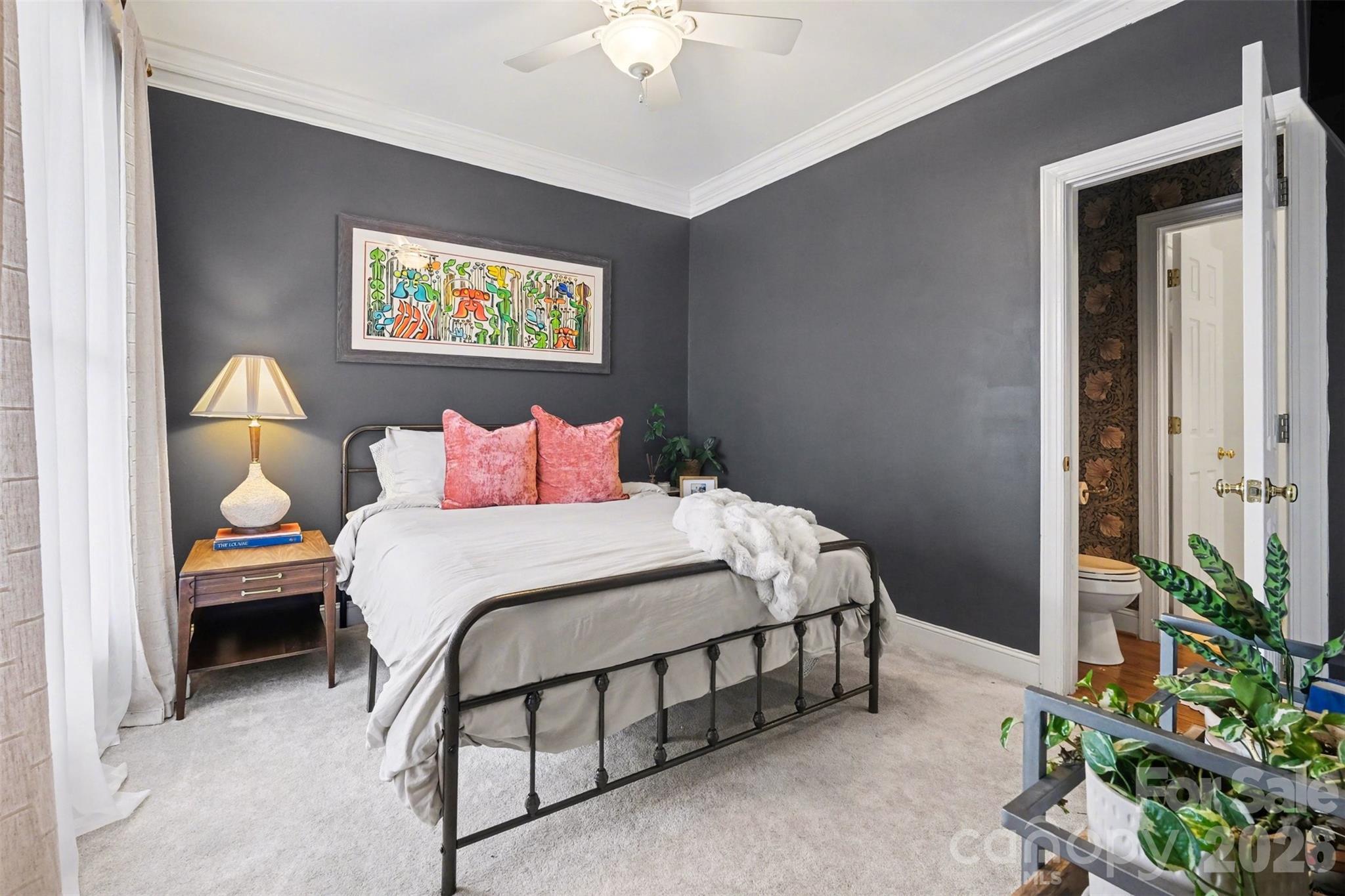 136 Spencer Street Davidson, NC 28036 - Photo 14 of 42 a bedroom with a bed table and a potted plant