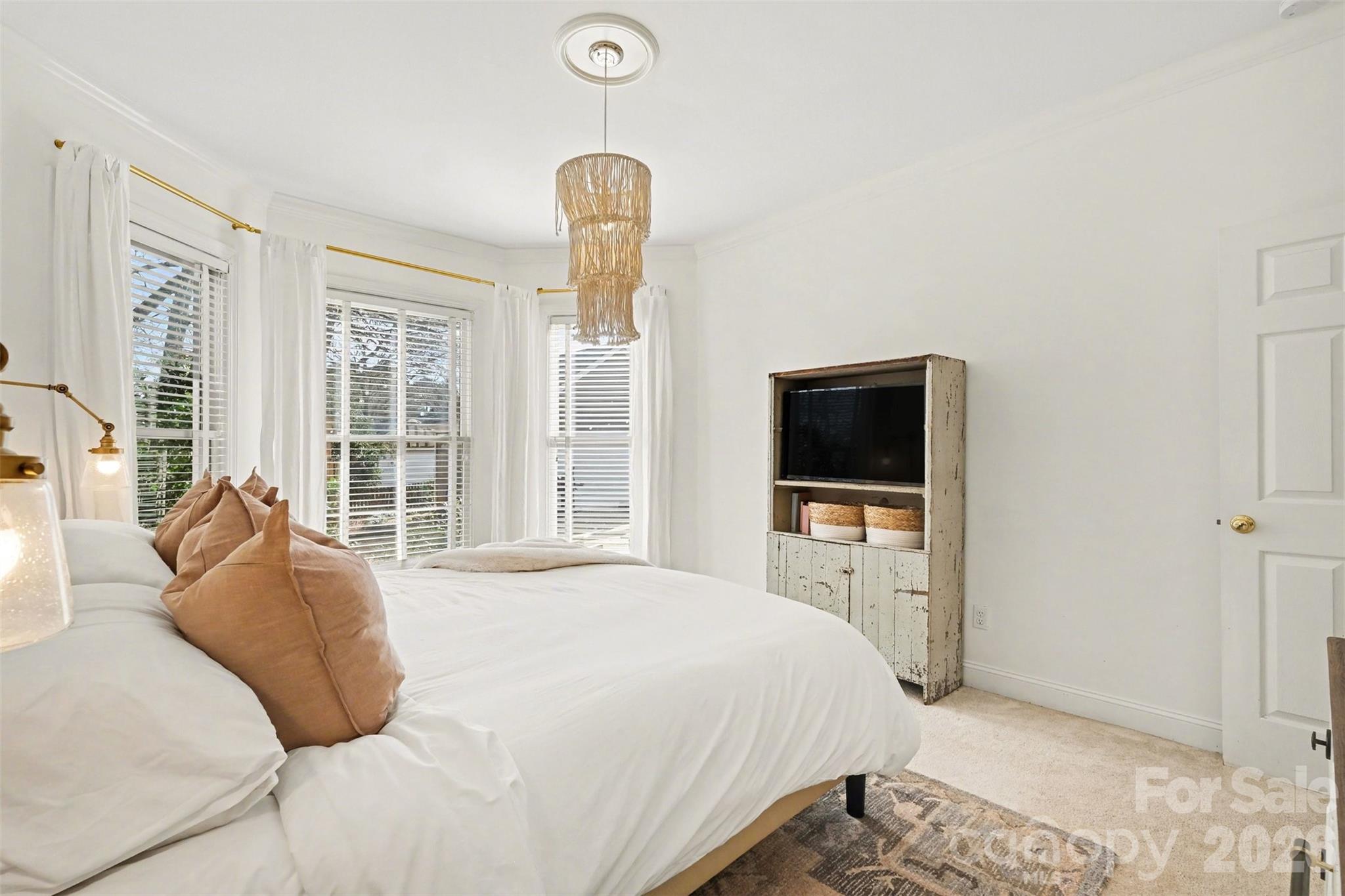 136 Spencer Street Davidson, NC 28036 - Photo 24 of 42 a bedroom with a bed and a flat screen tv