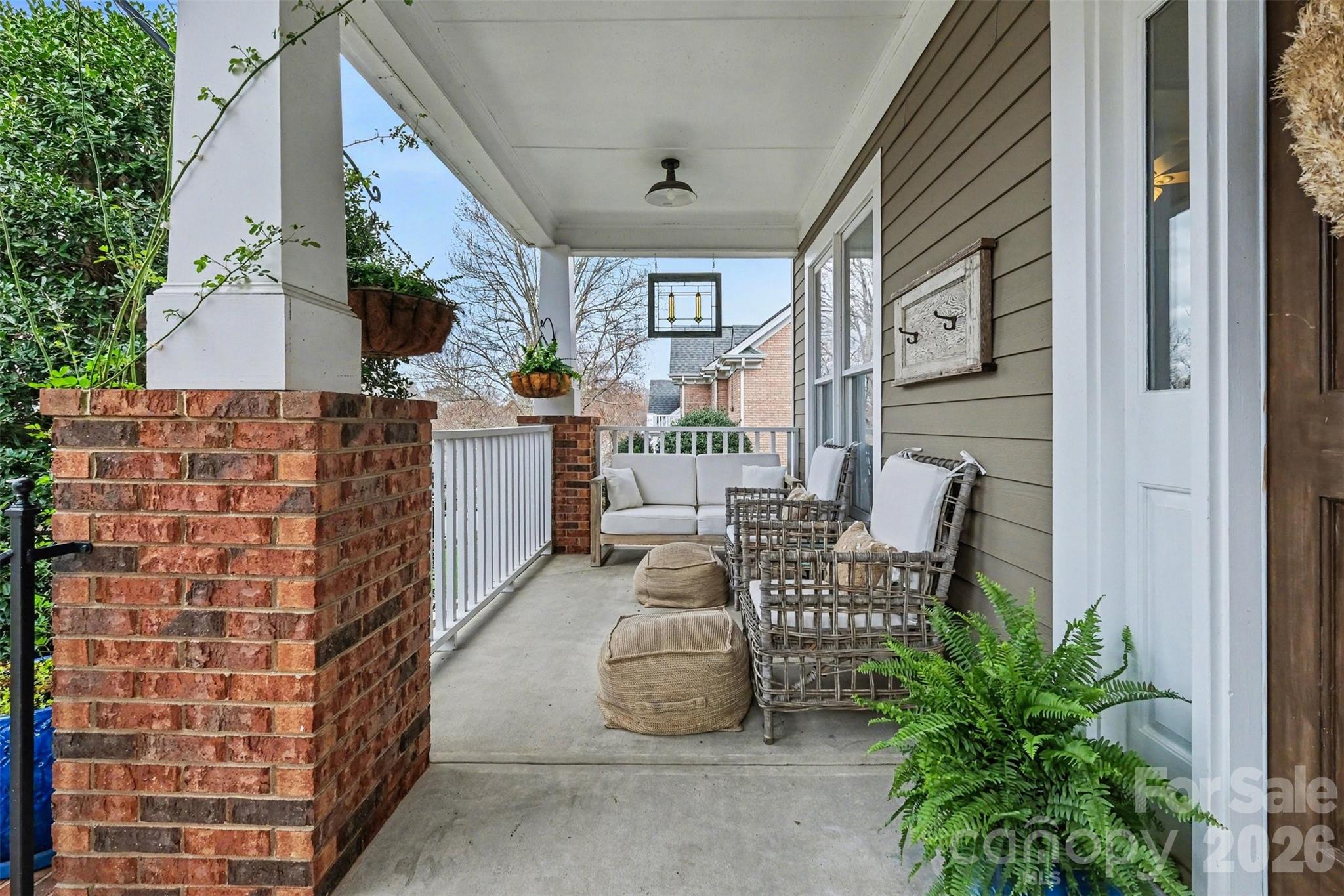 136 Spencer Street Davidson, NC 28036 - Photo 3 of 42 a balcony with furniture and a potted plant