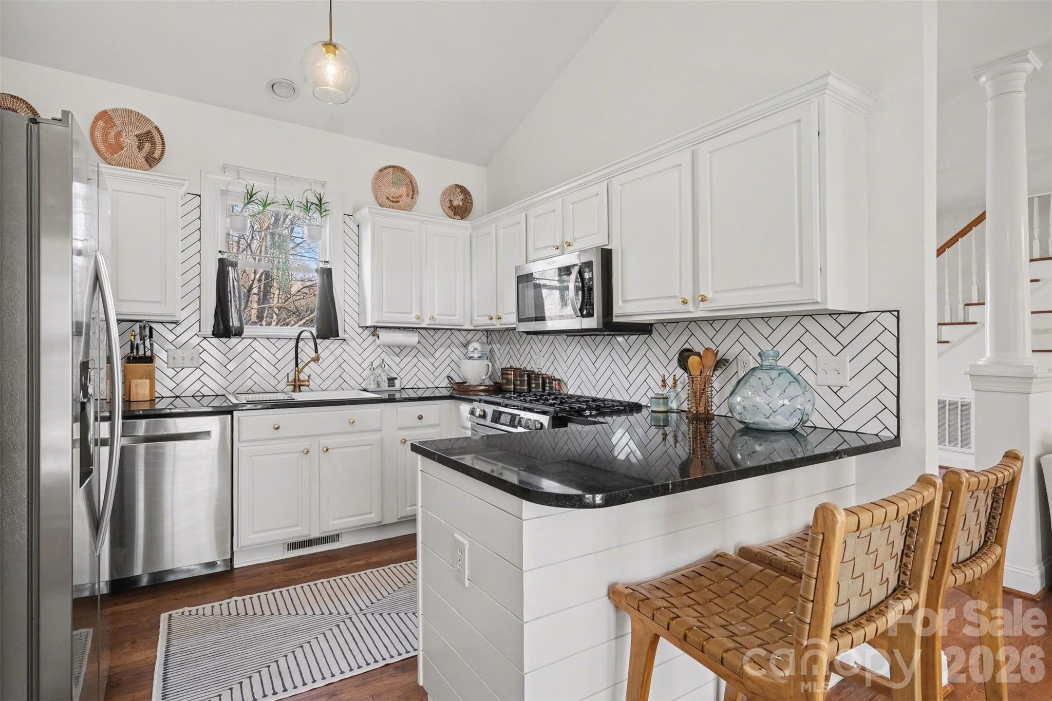 136 Spencer Street Davidson, NC 28036 - Photo 31 of 42 a kitchen with stainless steel appliances granite countertop a sink a stove and a refrigerator