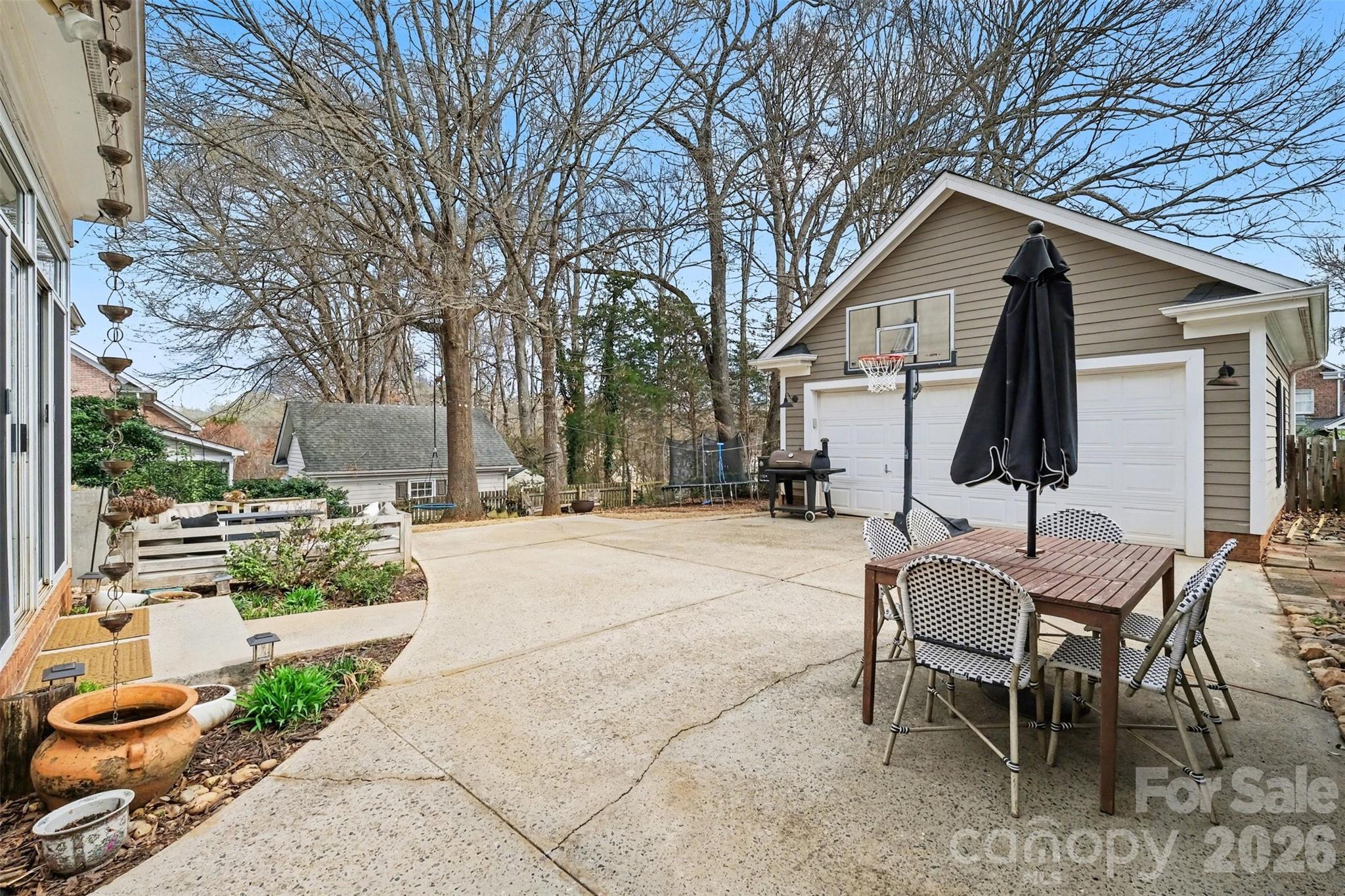136 Spencer Street Davidson, NC 28036 - Photo 34 of 42 a view of a patio with table and chairs and potted plants