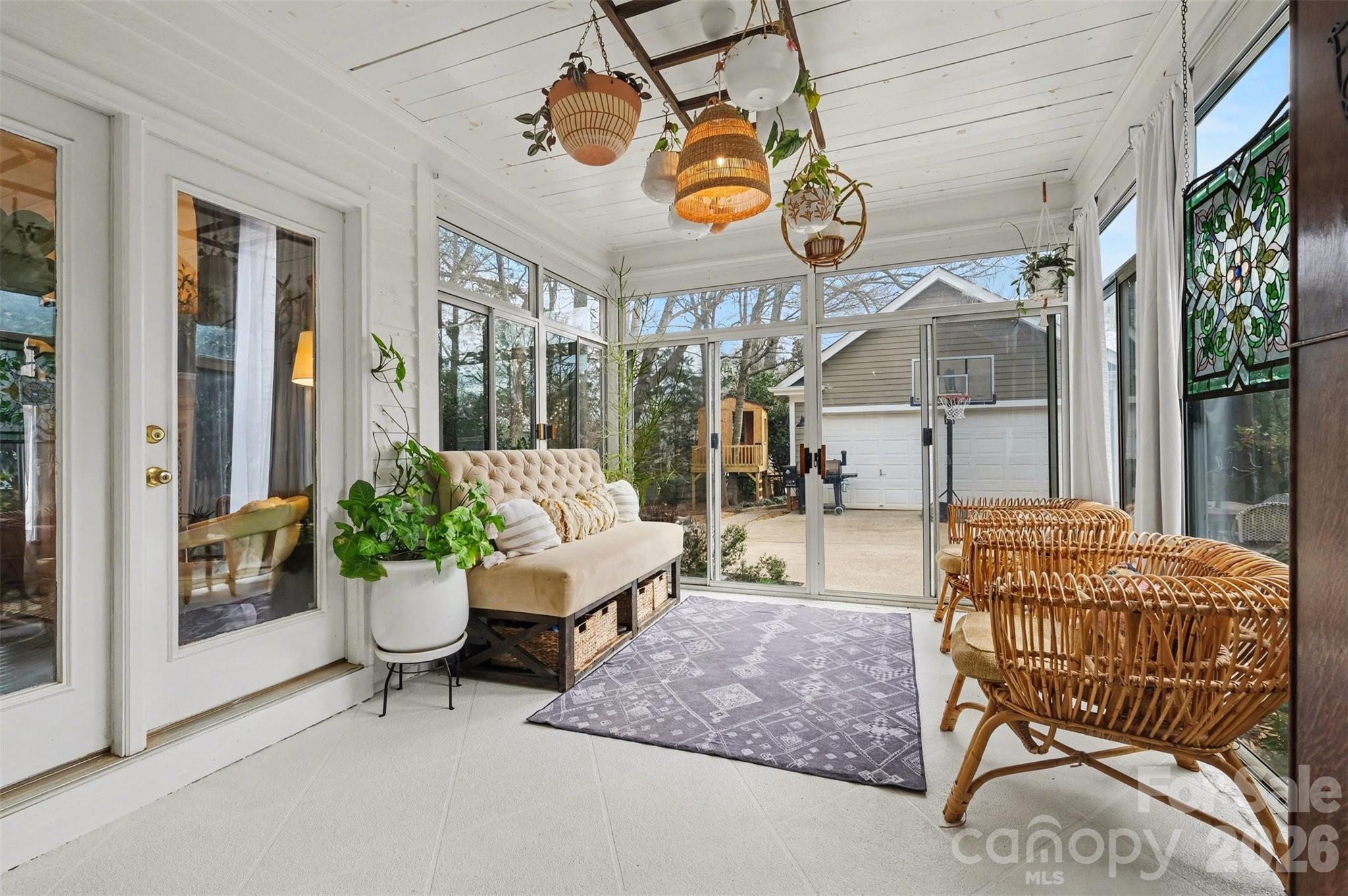 136 Spencer Street Davidson, NC 28036 - Photo 4 of 42 a living room with patio furniture and a large window
