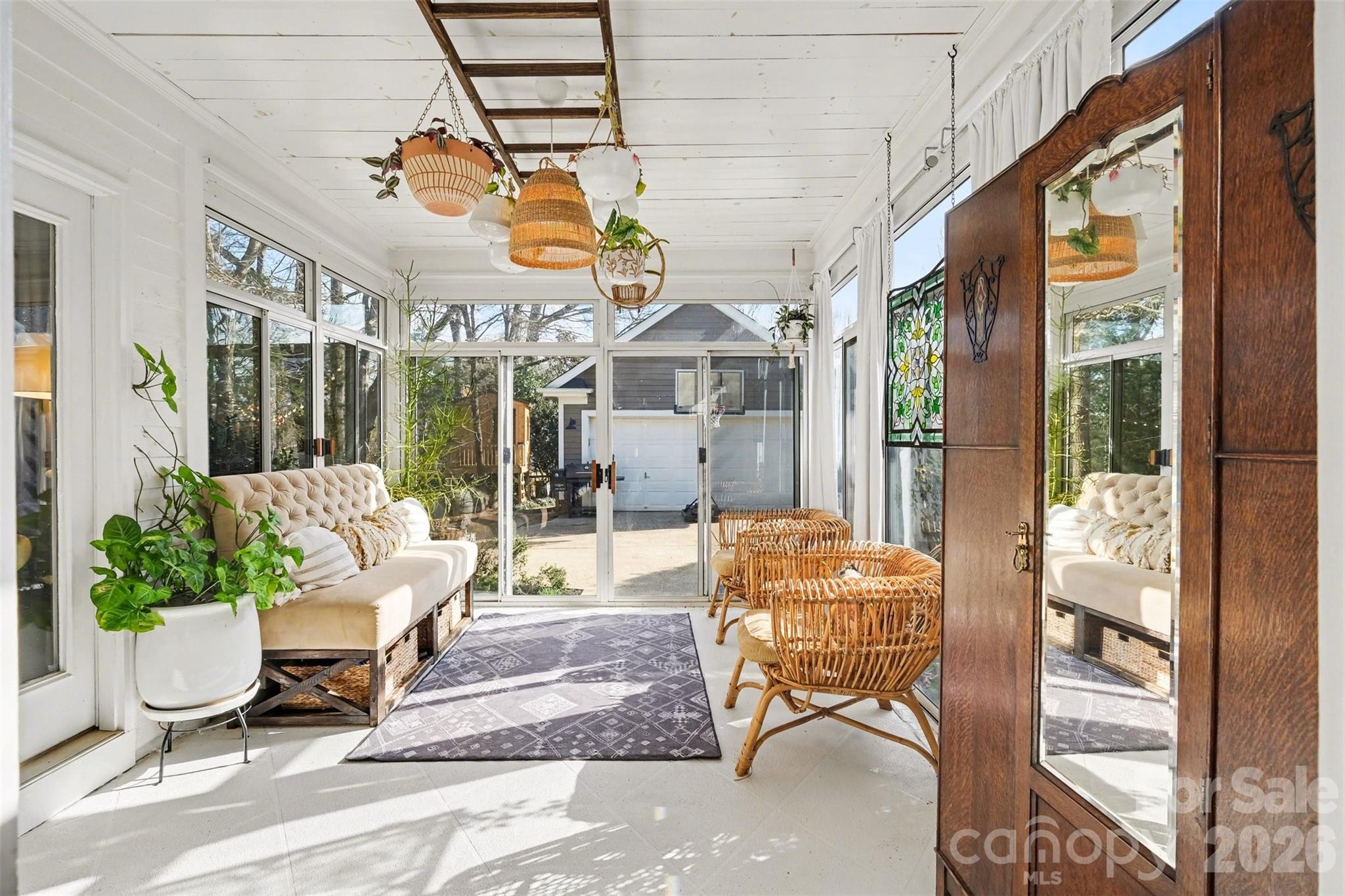 136 Spencer Street Davidson, NC 28036 - Photo 6 of 42 a outdoor space with patio the couches and a dining table with the view of the house