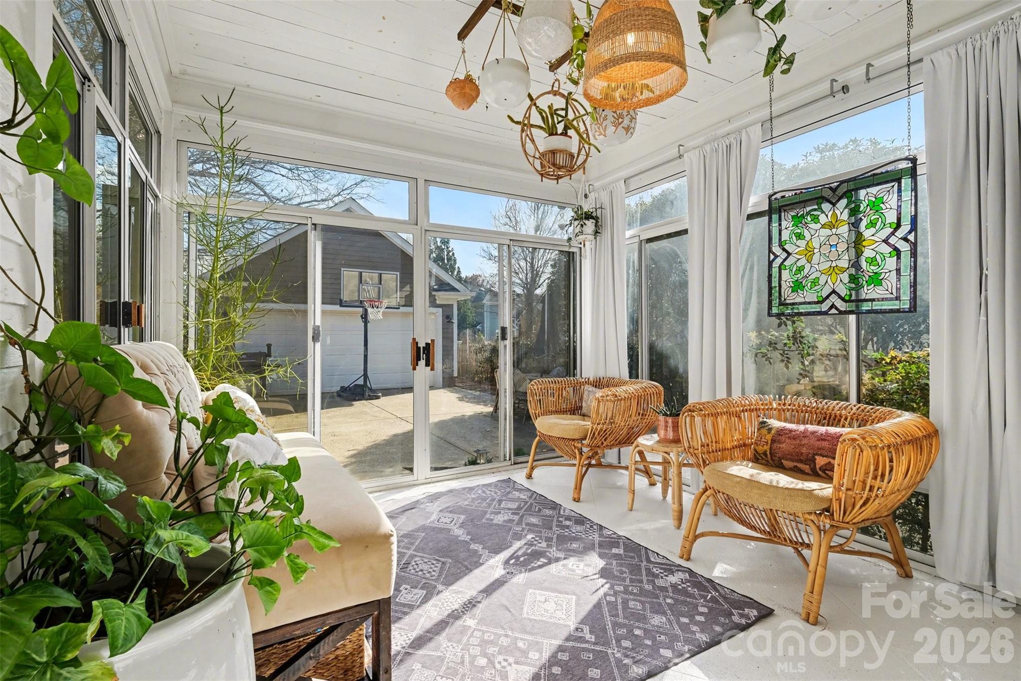 136 Spencer Street Davidson, NC 28036 - Photo 7 of 42 a outdoor living space with patio furniture and a potted plant