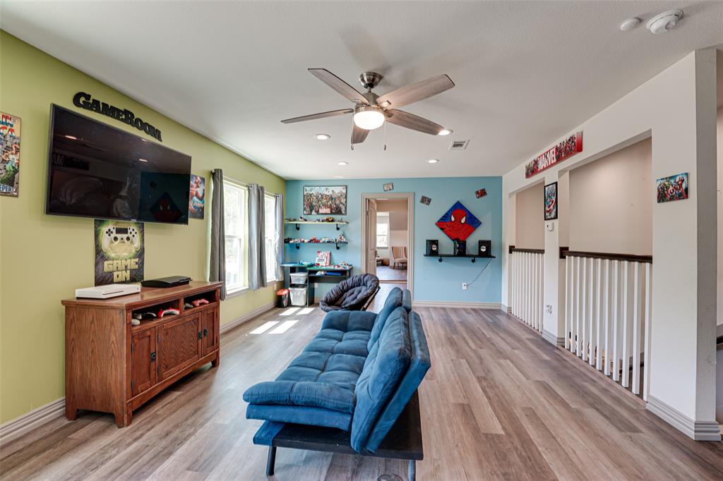 521 Bakers Branch Road Waxahachie, TX 75167 - Photo 33 of 37 Spacious recreation room featuring wood-finish flooring, a ceiling fan with integrated lighting, recessed lighting, and multiple windows for natural illumination