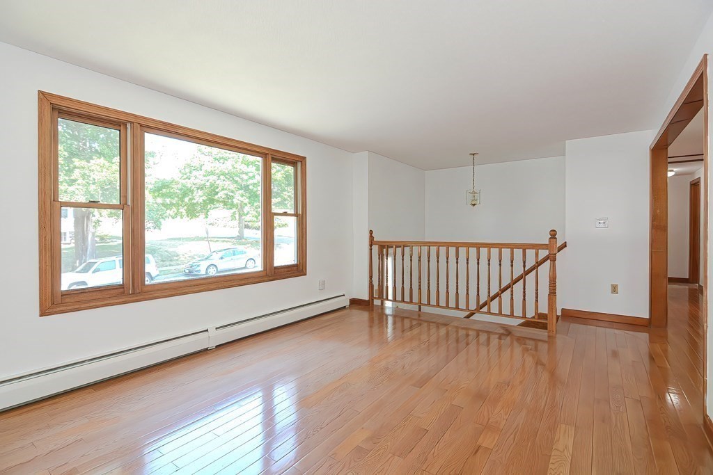 49 Hadwen Road Worcester, MA 01602 - Photo 3 of 28 a view of an empty room with wooden floor and a window