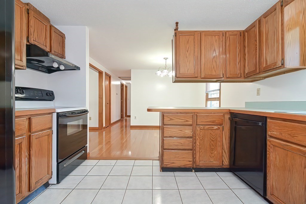 49 Hadwen Road Worcester, MA 01602 - Photo 6 of 28 a kitchen with stainless steel appliances granite countertop a refrigerator and a stove top oven