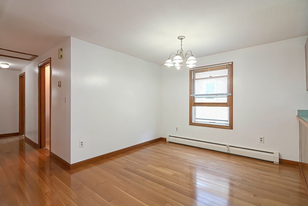 49 Hadwen Road Worcester, MA 01602 - Photo 8 of 28 an empty room with wooden floor and windows