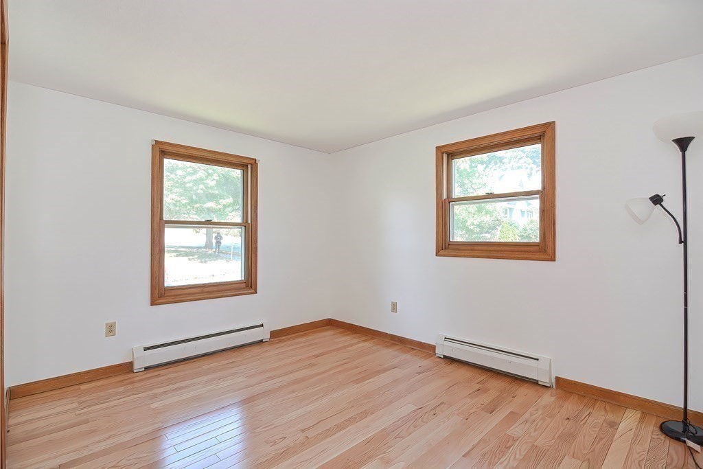 49 Hadwen Road Worcester, MA 01602 - Photo 10 of 28 a view of an empty room with wooden floor and a window