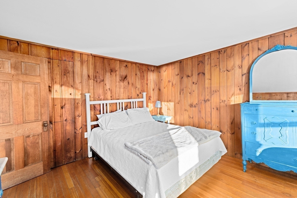 133 Phillips Road Bourne, MA 02562 - Photo 25 of 42 a bedroom with a bed and a painting on the wall