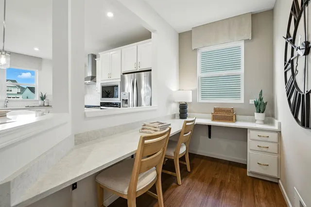 a kitchen with a table chairs sink and cabinets