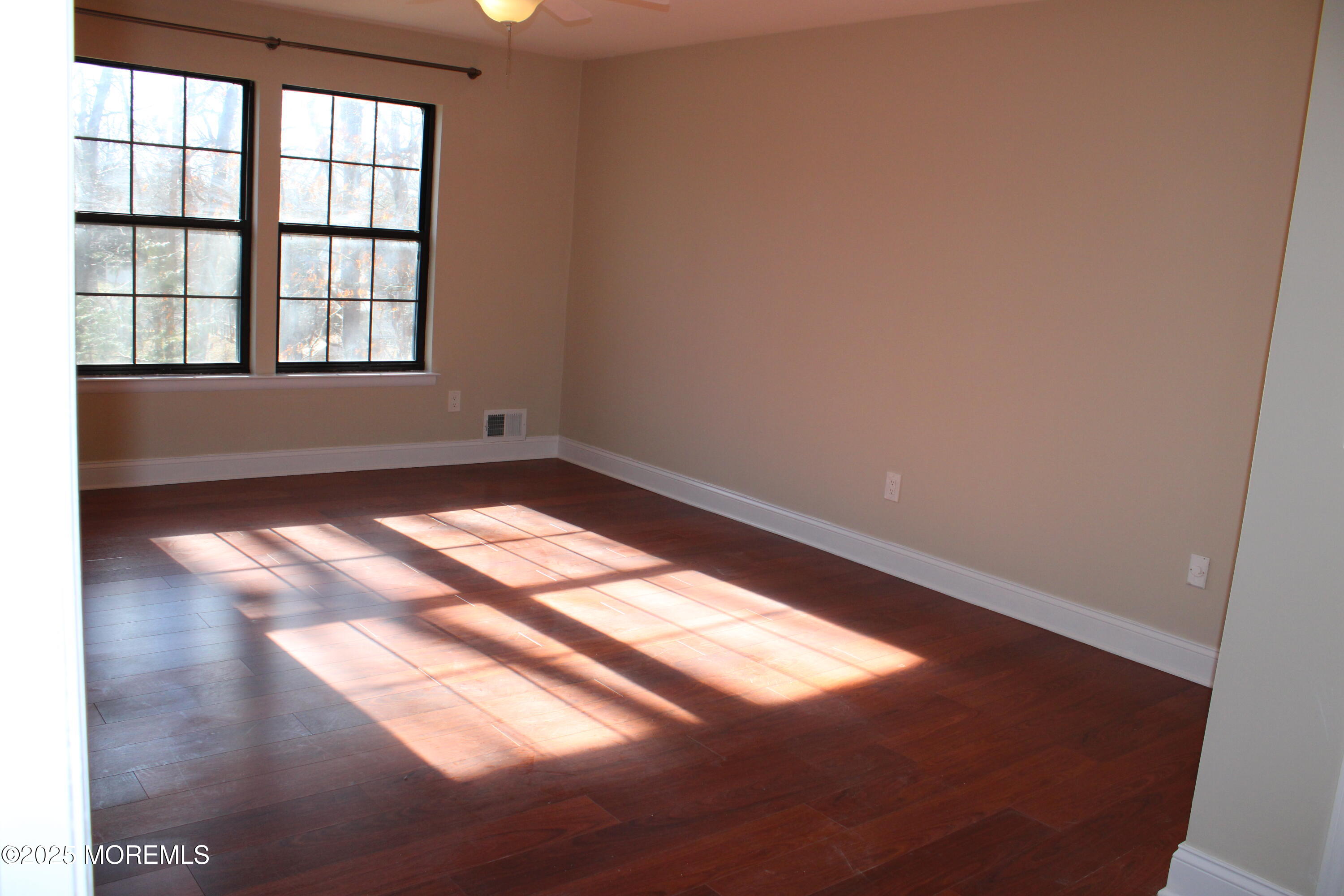 94 Azalea Circle Jackson, NJ 08527 - Photo 11 of 31 an empty room with wooden floor and windows
