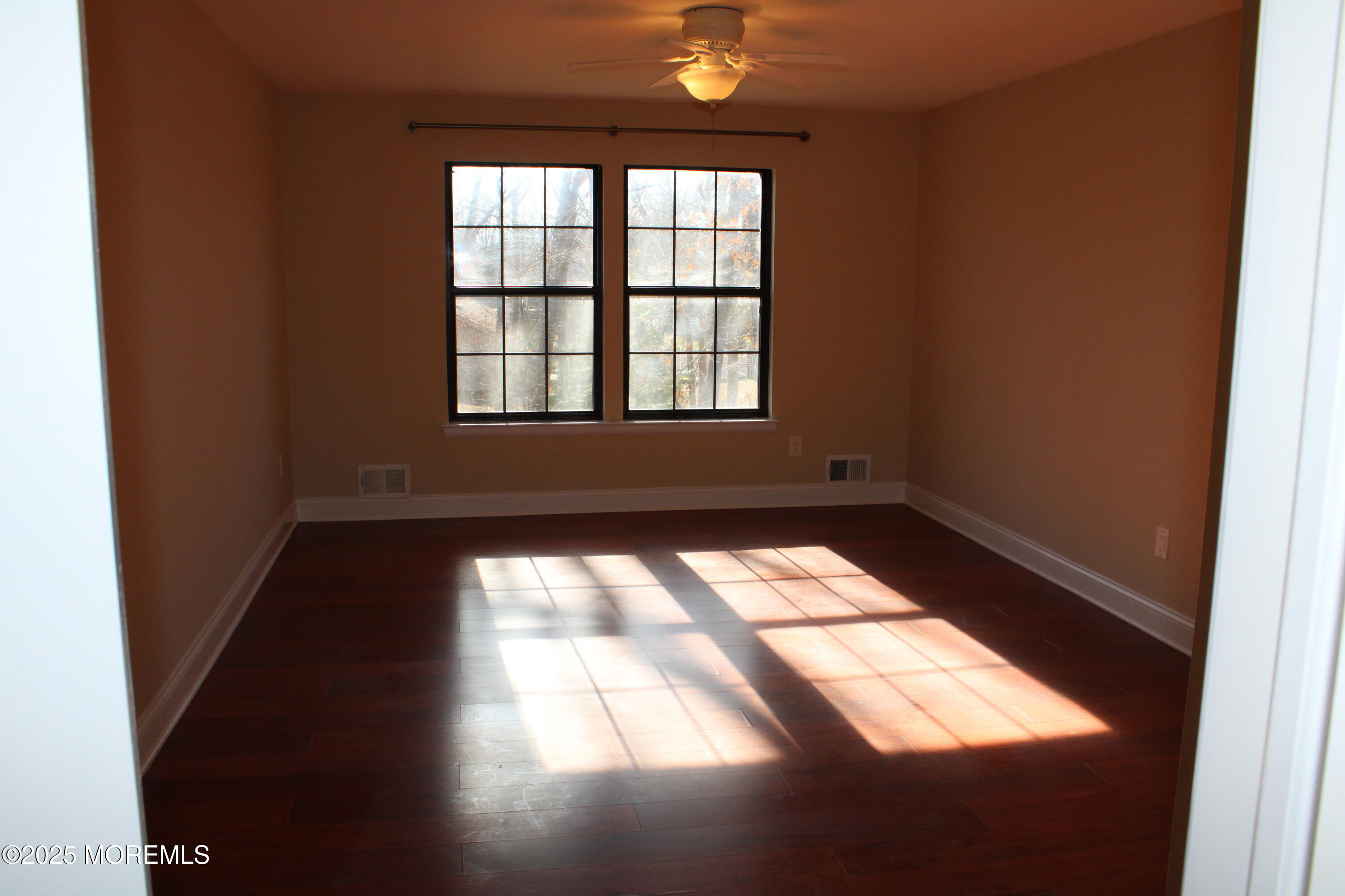 94 Azalea Circle Jackson, NJ 08527 - Photo 12 of 31 an empty room with wooden floor and windows
