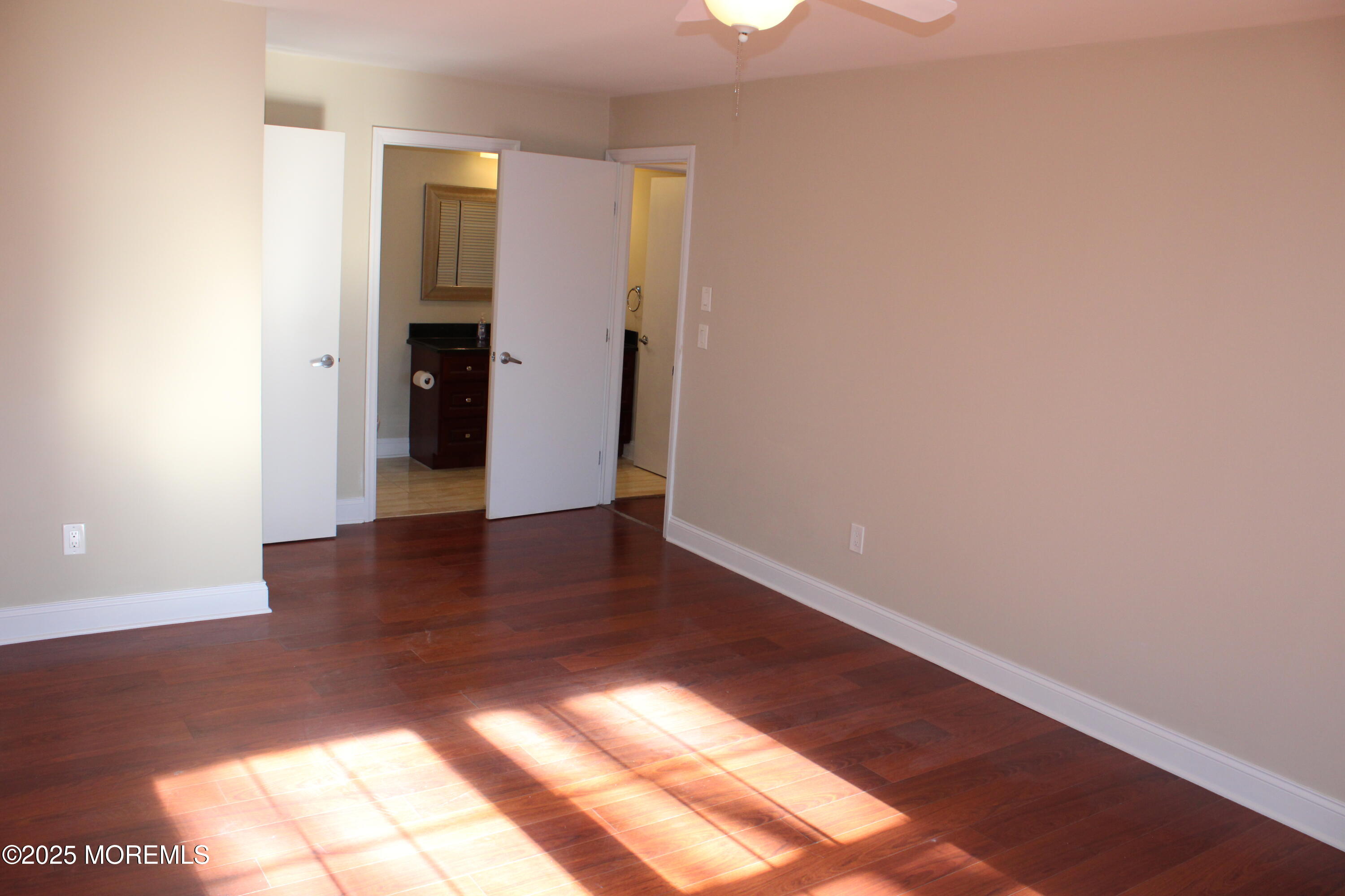94 Azalea Circle Jackson, NJ 08527 - Photo 13 of 31 a view of an empty room with wooden floor and a window