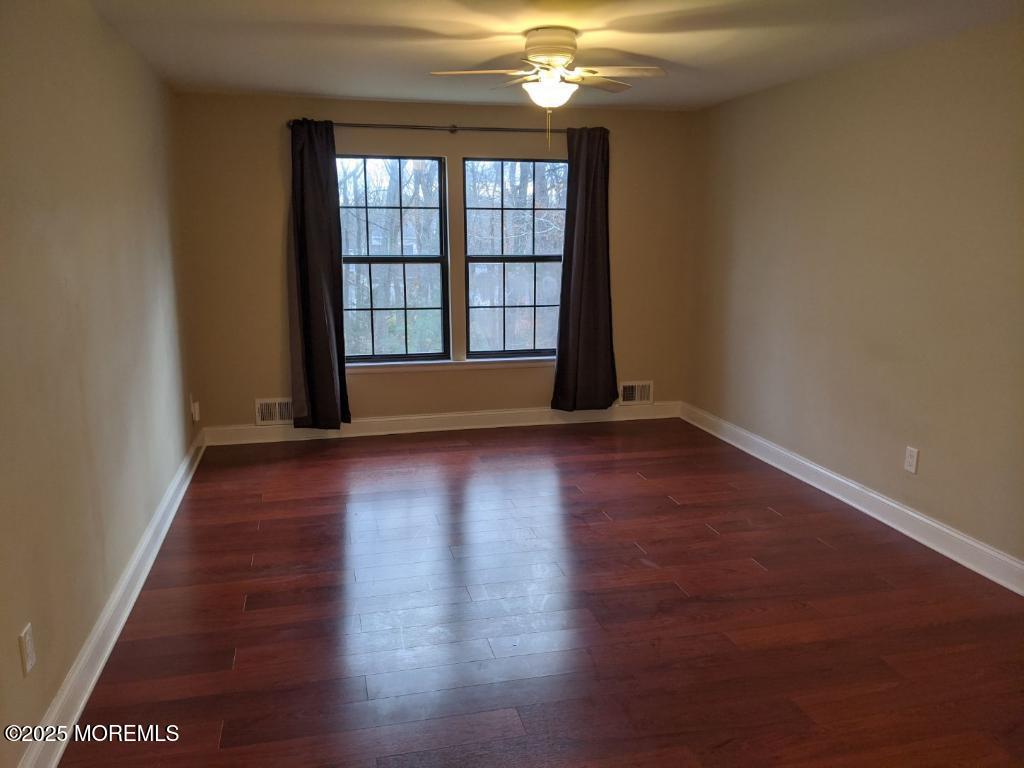 94 Azalea Circle Jackson, NJ 08527 - Photo 17 of 31 an empty room with wooden floor and windows