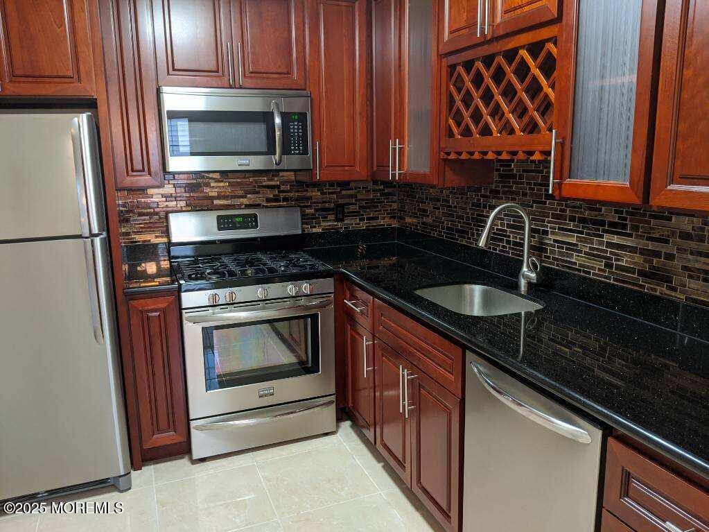 94 Azalea Circle Jackson, NJ 08527 - Photo 3 of 31 a kitchen with granite countertop a sink stove and microwave