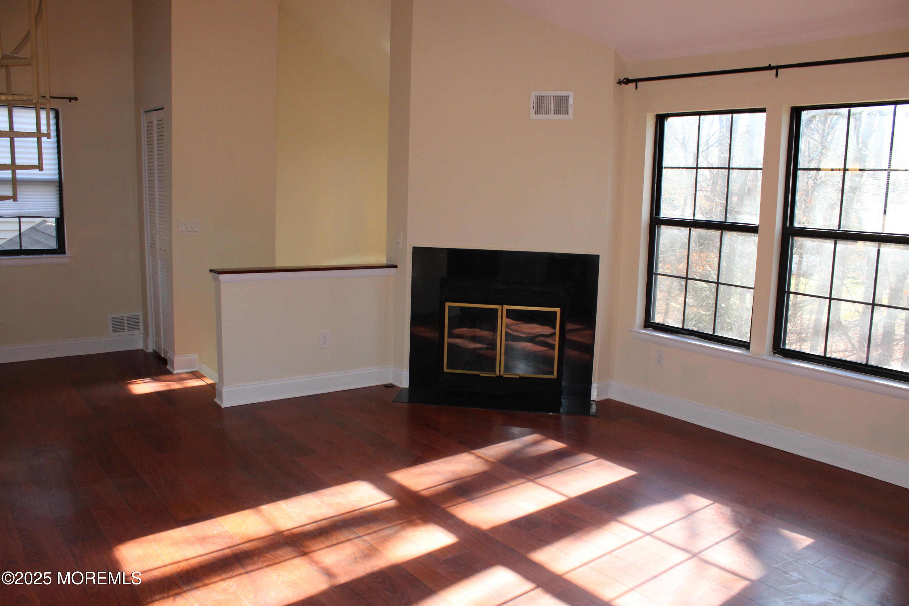 94 Azalea Circle Jackson, NJ 08527 - Photo 9 of 31 a view of an empty room with glass door and wooden floor