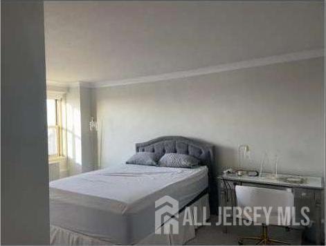 28 Riverside Avenue, Unit 11H Red Bank, NJ 07701 - Photo 4 of 5 a bedroom with a bed and window