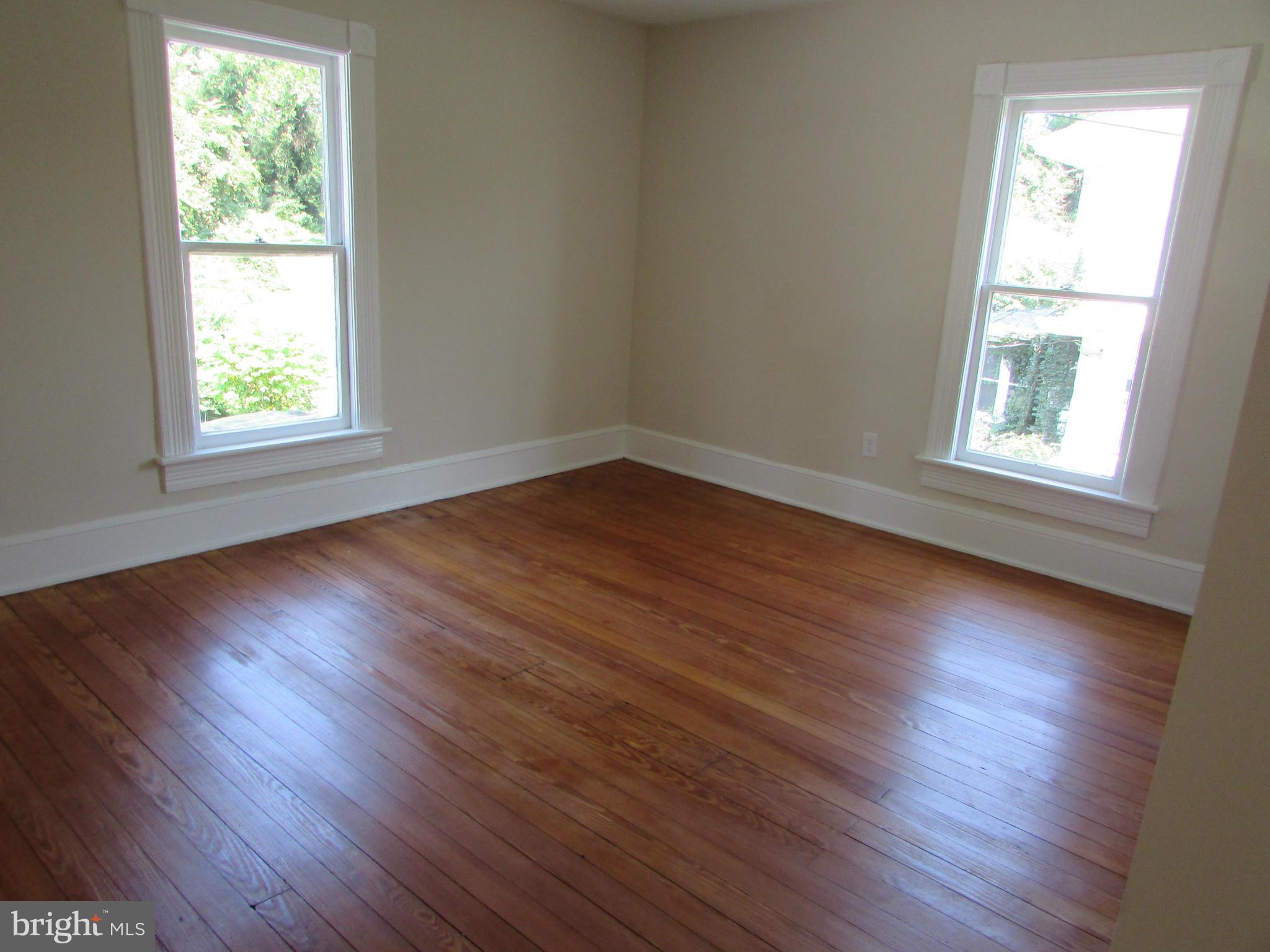 9520 Main Street Manassas, VA 20110 - Photo 12 of 19 an empty room with wooden floor and windows