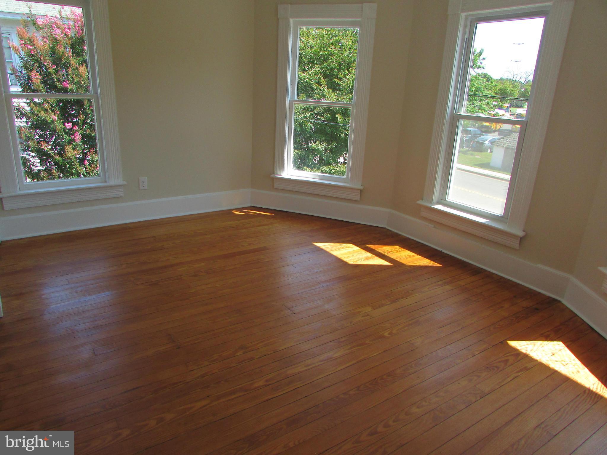 9520 Main Street Manassas, VA 20110 - Photo 14 of 19 an empty room with wooden floor and windows