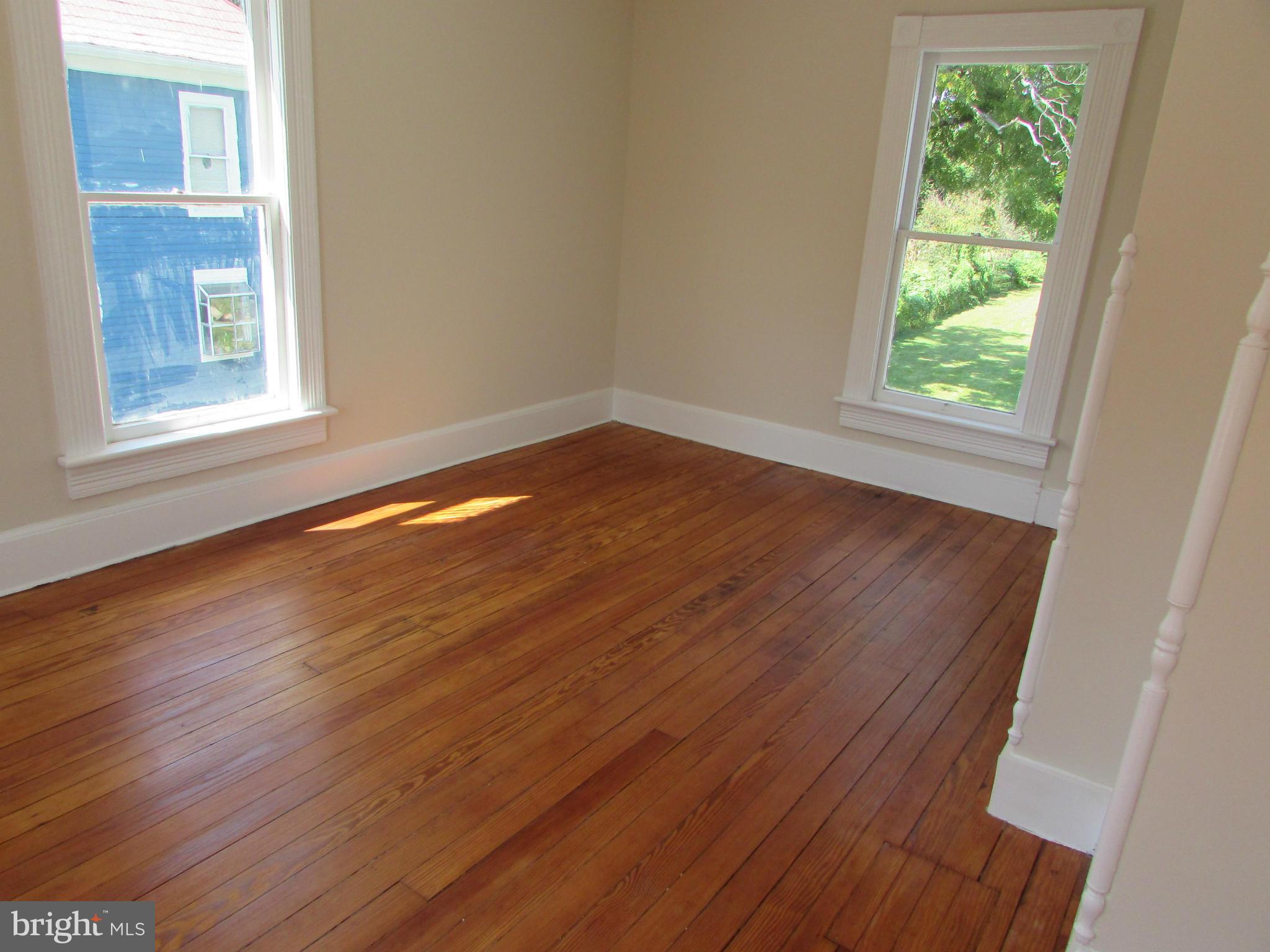 9520 Main Street Manassas, VA 20110 - Photo 16 of 19 a view of an empty room with wooden floor and a window