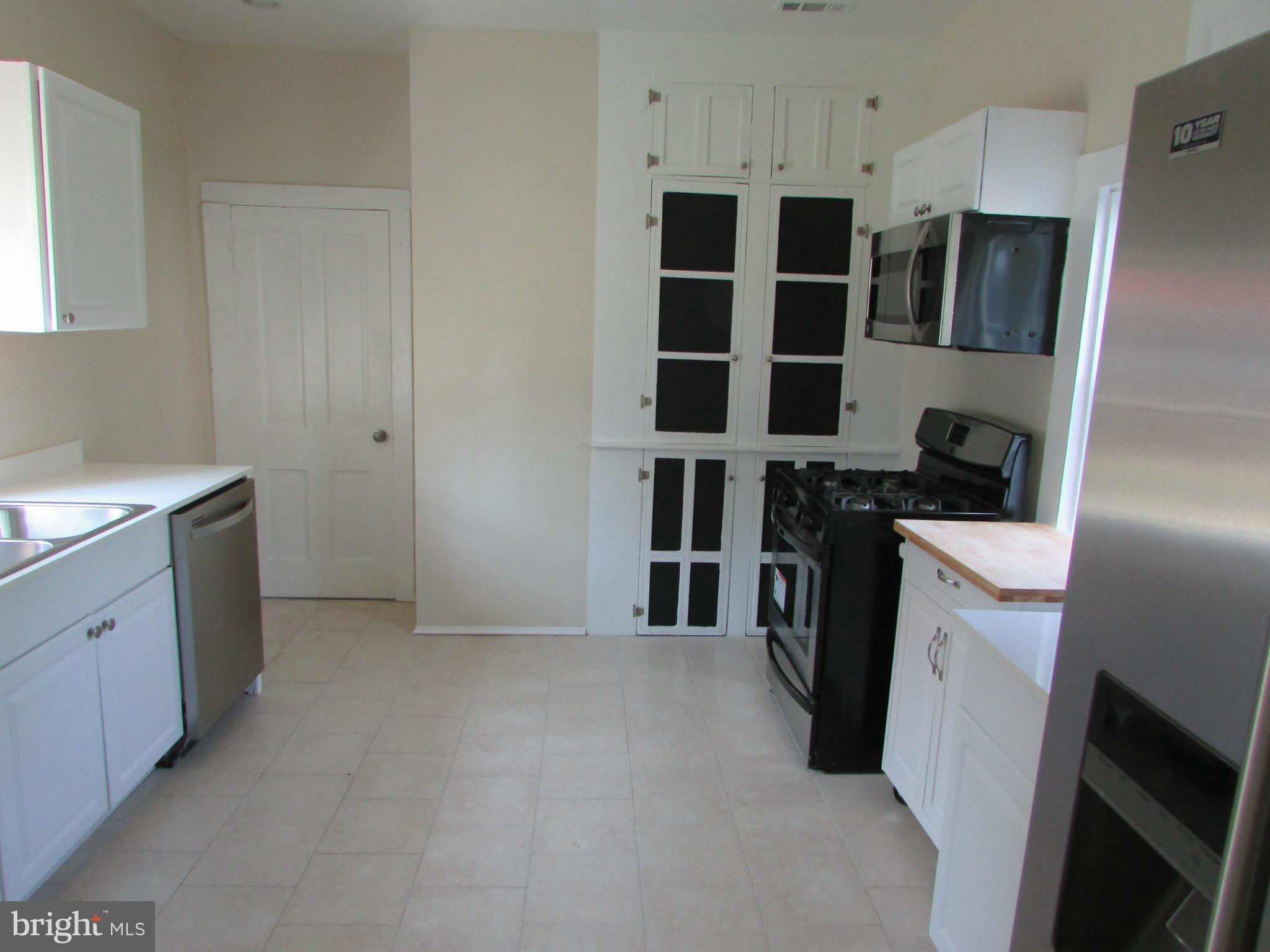 9520 Main Street Manassas, VA 20110 - Photo 3 of 19 a view of a kitchen with electric appliances