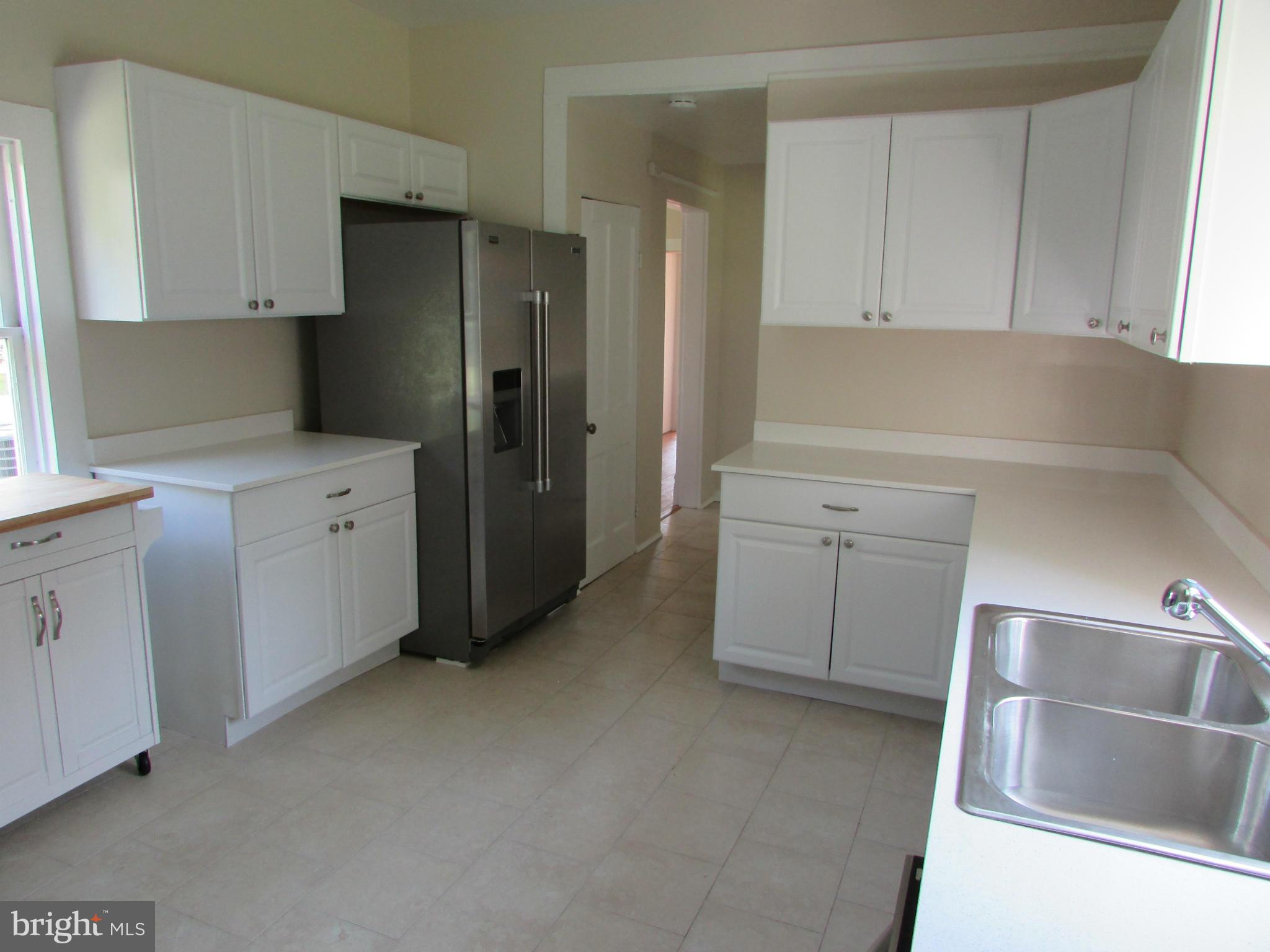 9520 Main Street Manassas, VA 20110 - Photo 4 of 19 a kitchen with a refrigerator sink and cabinets