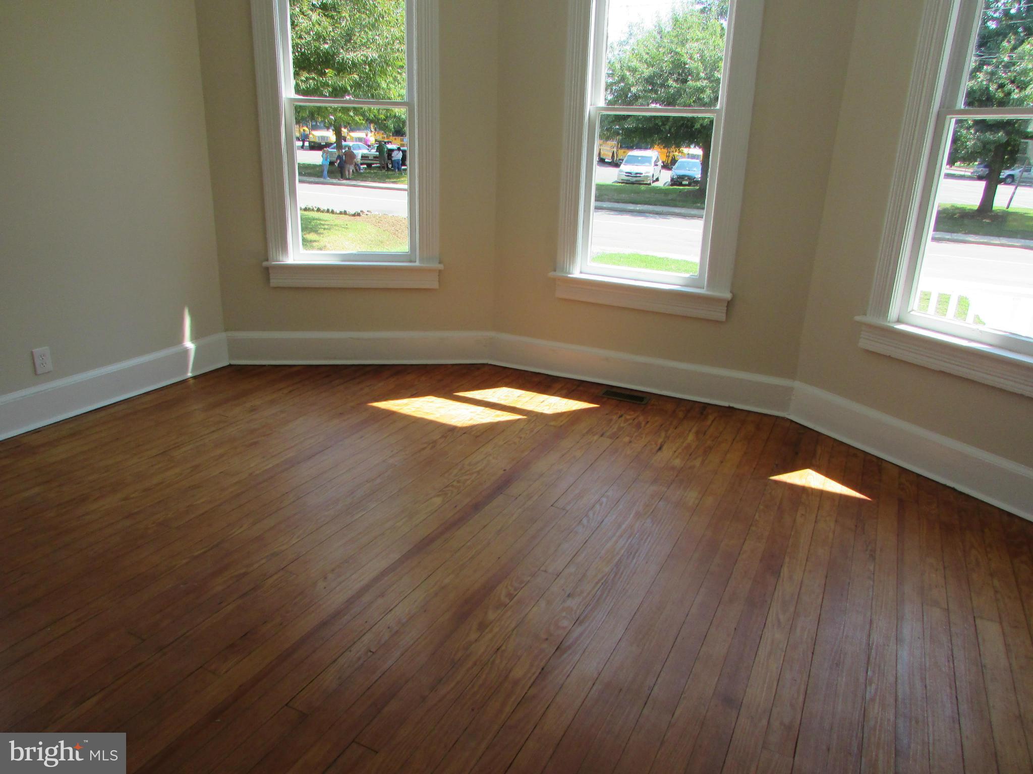 9520 Main Street Manassas, VA 20110 - Photo 6 of 19 an empty room with wooden floor and windows