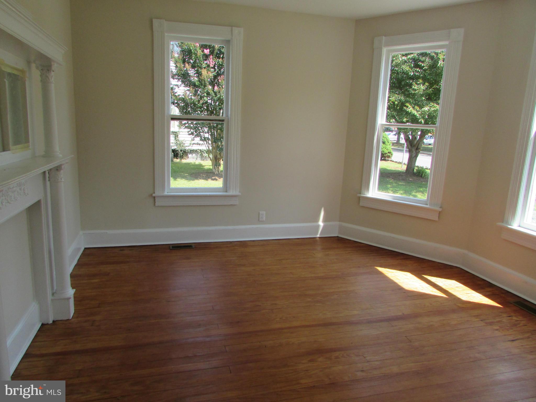 9520 Main Street Manassas, VA 20110 - Photo 7 of 19 a view of an empty room with wooden floor and a window